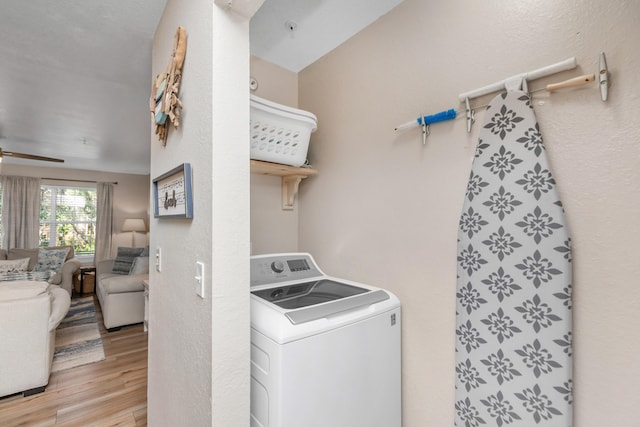 laundry area with ceiling fan, laundry area, light wood finished floors, and washer / dryer