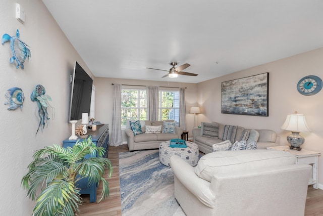 living area with light wood-type flooring and ceiling fan