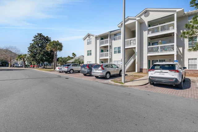 view of building exterior featuring uncovered parking