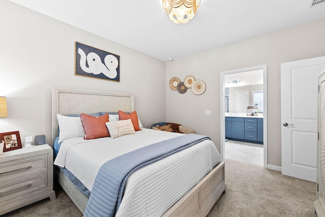 bedroom with light carpet, connected bathroom, visible vents, and baseboards