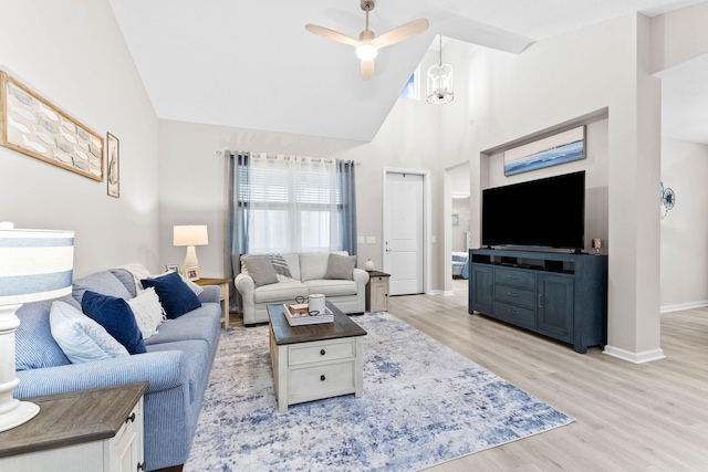 living room featuring high vaulted ceiling, baseboards, light wood finished floors, and a ceiling fan