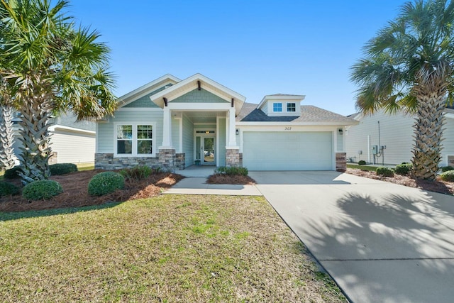 view of front of home featuring an attached garage, stone siding, a front lawn, and concrete driveway