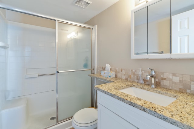 bathroom with visible vents, decorative backsplash, toilet, a shower stall, and vanity