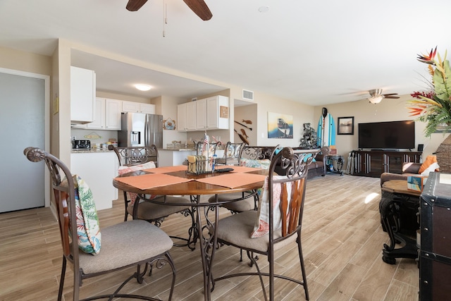 dining area featuring a ceiling fan, light wood-type flooring, and visible vents