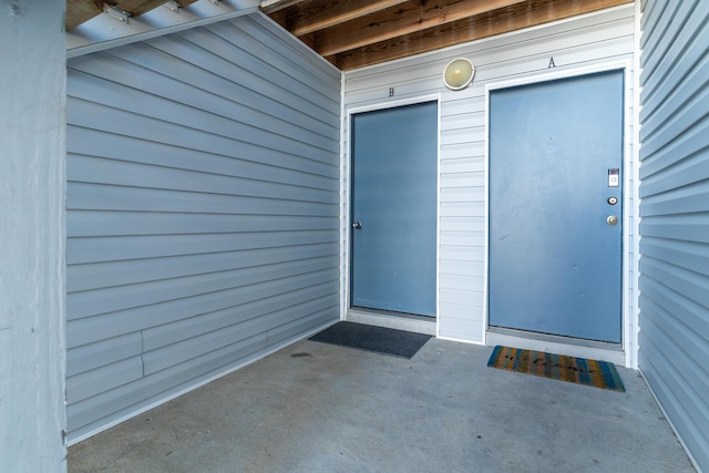 view of exterior entry featuring a patio area