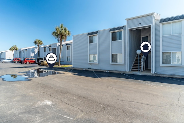 view of property featuring uncovered parking and a residential view