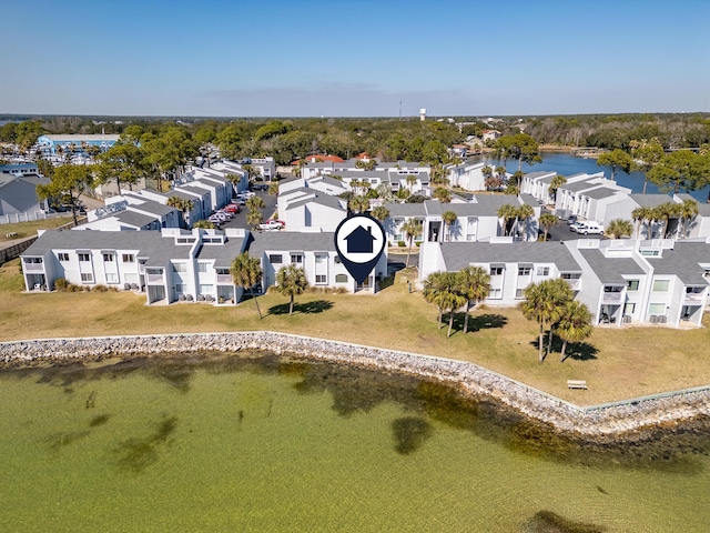 birds eye view of property with a water view and a residential view