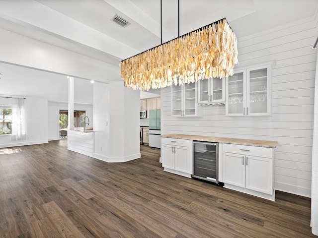 kitchen featuring wine cooler, refrigerator, white cabinets, light countertops, and glass insert cabinets