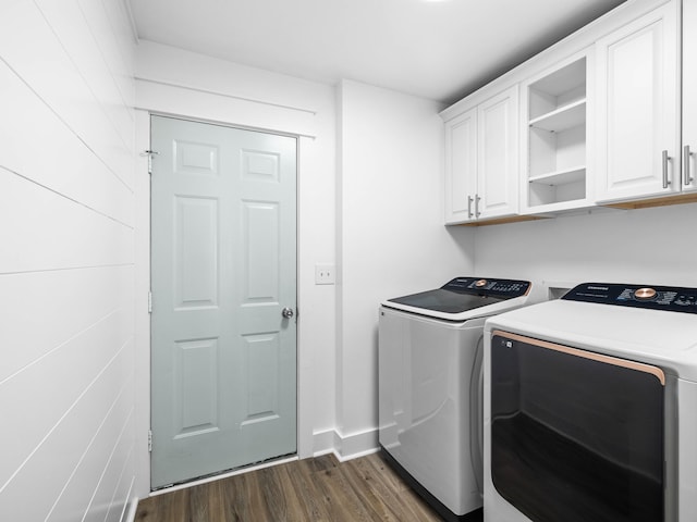 washroom with dark wood-type flooring, cabinet space, baseboards, and separate washer and dryer