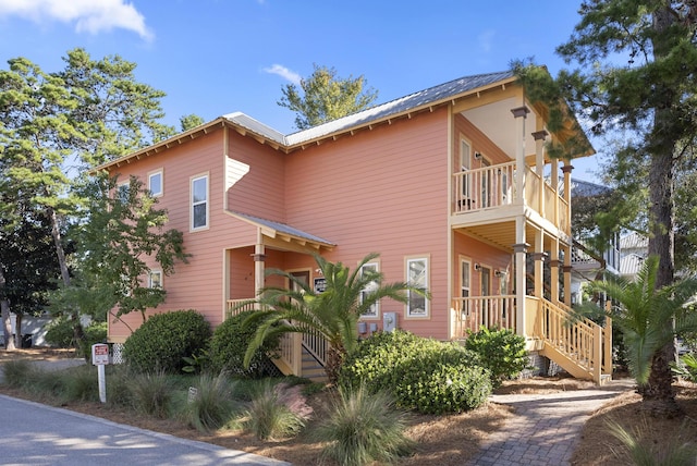 view of side of property with a balcony