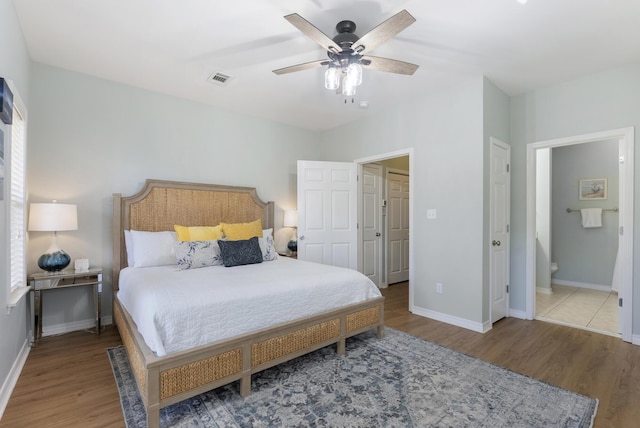 bedroom featuring multiple windows, wood finished floors, and baseboards