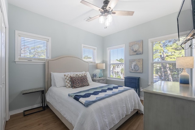 bedroom featuring a ceiling fan, baseboards, and dark wood-style flooring