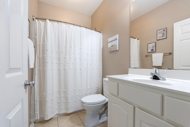 full bathroom with toilet, vanity, and tile patterned floors