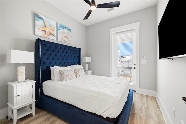 bedroom with light wood-style flooring, visible vents, baseboards, and ceiling fan