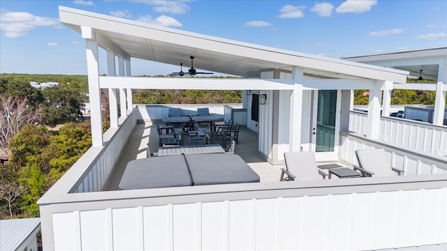 view of patio featuring outdoor dining area and a ceiling fan