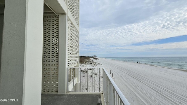 exterior space with a water view and a beach view