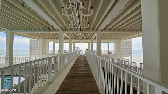 corridor with a water view and a view of the beach