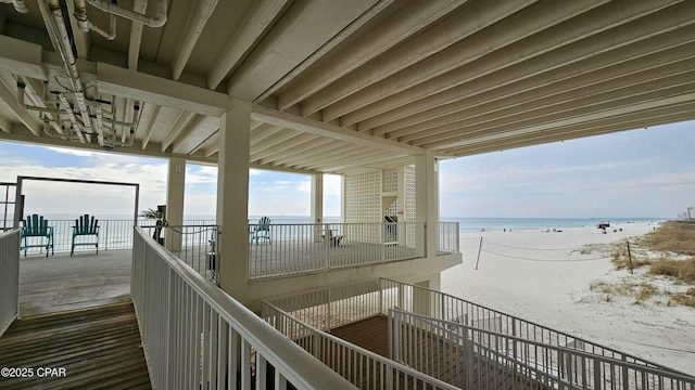 exterior space featuring a water view and a beach view