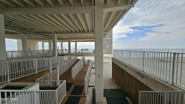 exterior space featuring a beach view and a water view