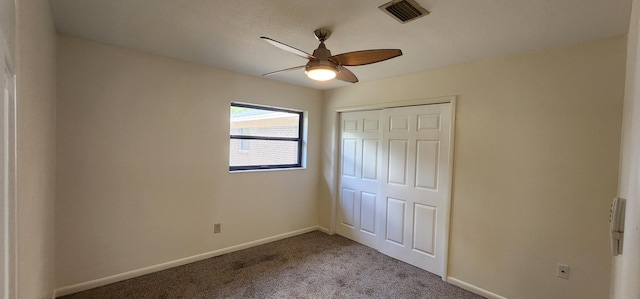 unfurnished bedroom with visible vents, a closet, baseboards, and carpet flooring