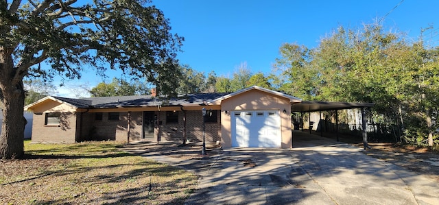 single story home featuring driveway, a carport, an attached garage, and brick siding