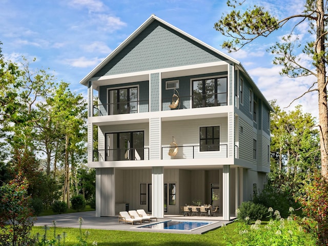 rear view of property with a balcony, an outdoor pool, board and batten siding, and a patio