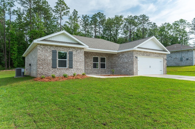 view of front facade with a front lawn, cooling unit, brick siding, an attached garage, and driveway