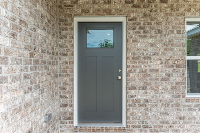 entrance to property with brick siding