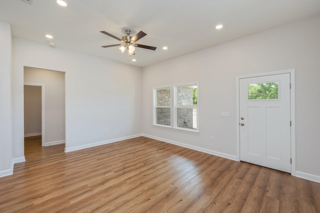 interior space with baseboards, a ceiling fan, and a wealth of natural light