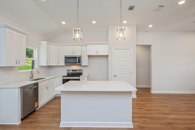 kitchen with visible vents, white cabinetry, a sink, light wood-style flooring, and appliances with stainless steel finishes
