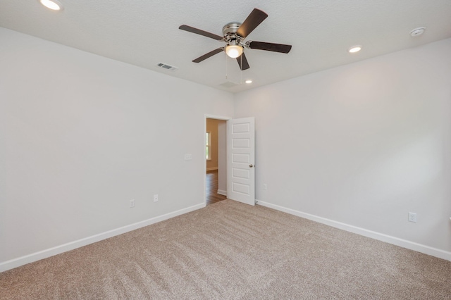 carpeted empty room featuring recessed lighting, baseboards, visible vents, and ceiling fan