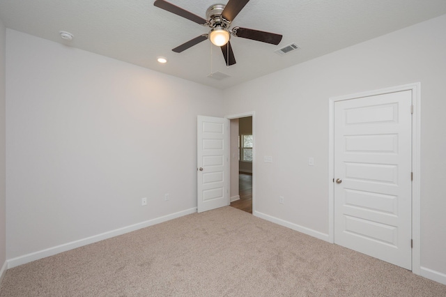 unfurnished bedroom with visible vents, recessed lighting, carpet, and baseboards