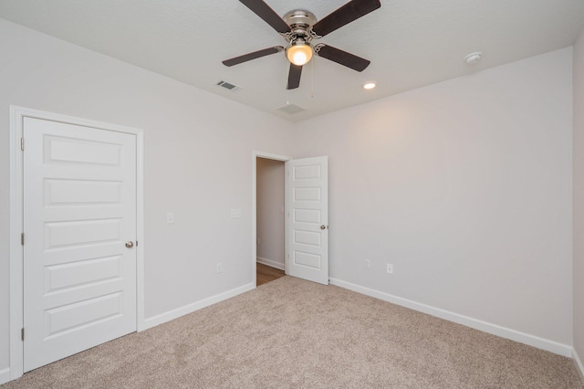 unfurnished bedroom with recessed lighting, baseboards, visible vents, and carpet