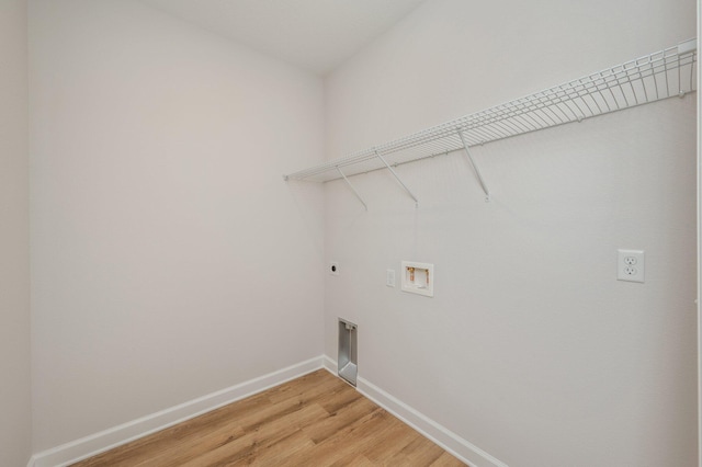 laundry area with laundry area, light wood-style floors, hookup for a washing machine, baseboards, and hookup for an electric dryer