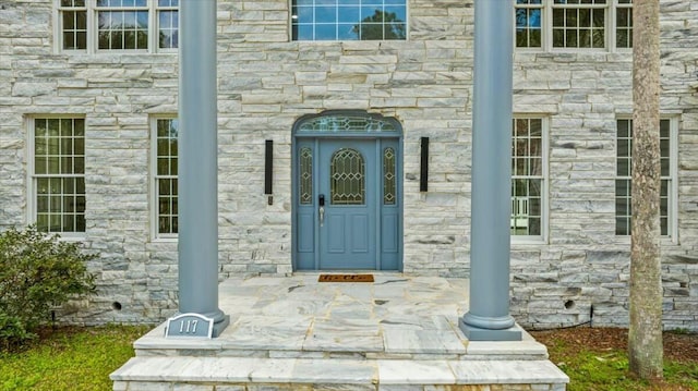 doorway to property featuring stone siding