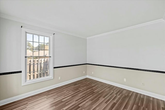 unfurnished room featuring crown molding, baseboards, and wood finished floors