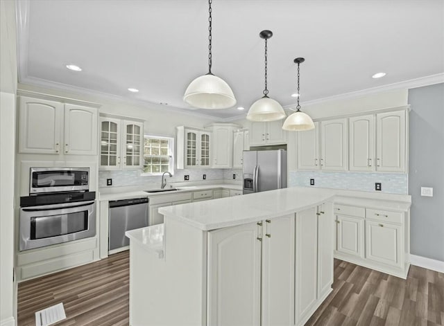 kitchen with stainless steel appliances, white cabinetry, visible vents, a center island, and glass insert cabinets