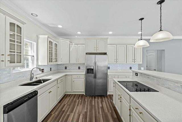 kitchen featuring dark wood-style floors, appliances with stainless steel finishes, a sink, and ornamental molding