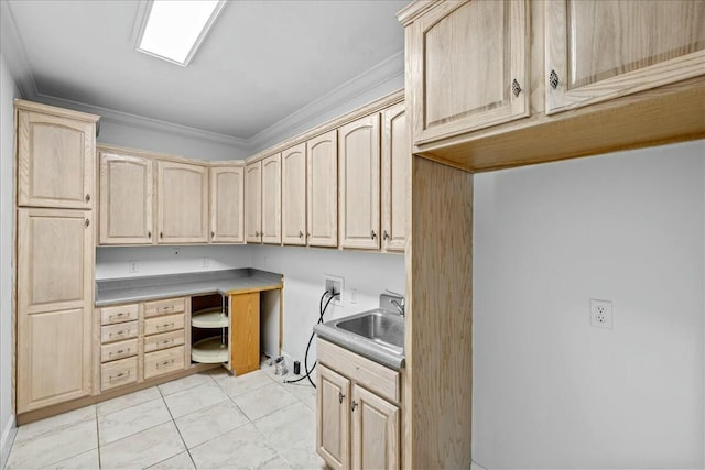 interior space featuring cabinet space, light tile patterned floors, crown molding, washer hookup, and a sink