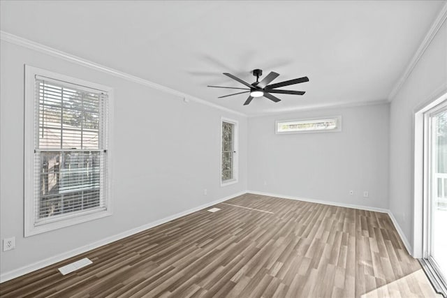 unfurnished room with ornamental molding, wood finished floors, and a healthy amount of sunlight