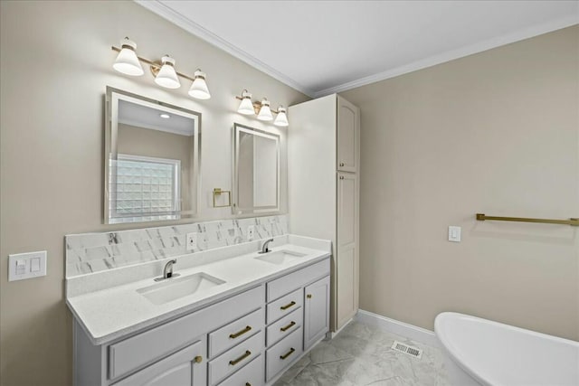 bathroom featuring marble finish floor, visible vents, a sink, and a soaking tub