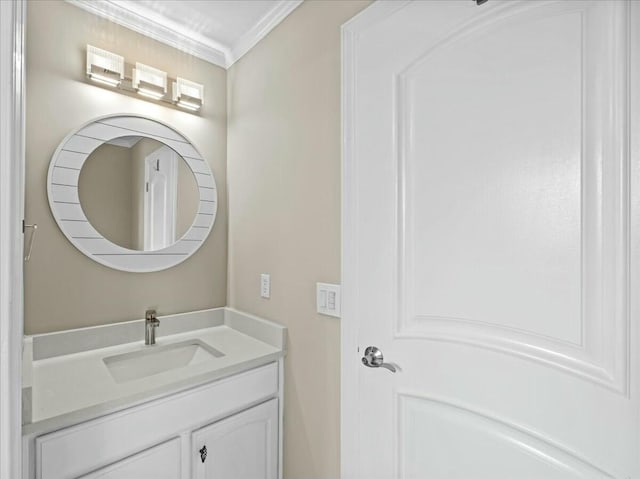 bathroom with ornamental molding and vanity