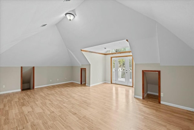 bonus room featuring light wood-style flooring and baseboards