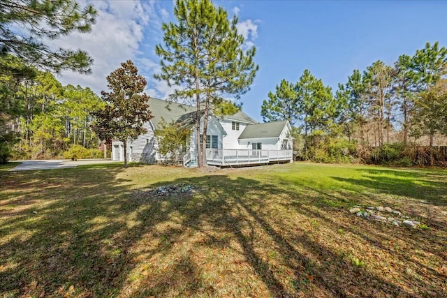 view of yard with a garage and a deck