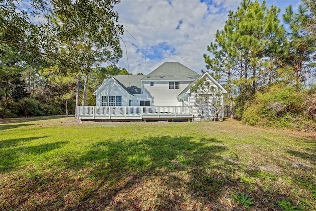 back of house featuring a deck and a lawn