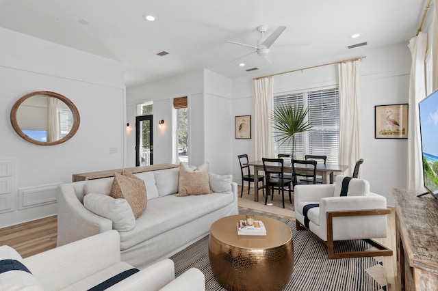 living room with light wood-style flooring, visible vents, a ceiling fan, and recessed lighting