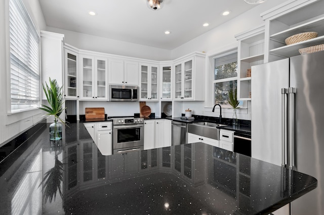 kitchen featuring open shelves, stainless steel appliances, recessed lighting, white cabinets, and a sink