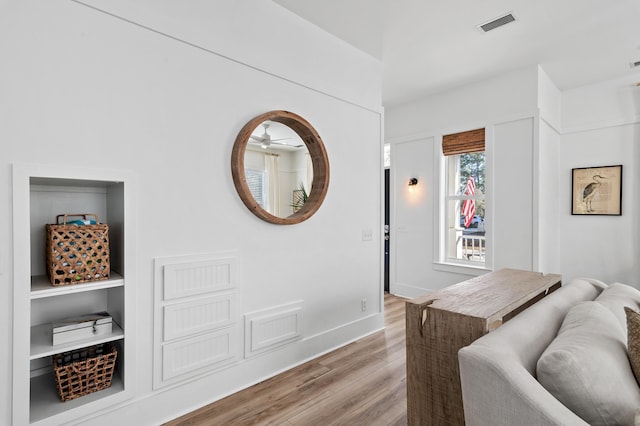 bedroom featuring light wood finished floors, baseboards, and visible vents