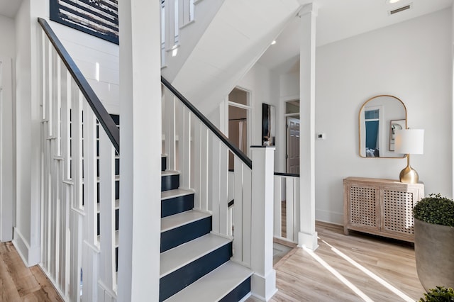 stairs featuring visible vents and wood finished floors