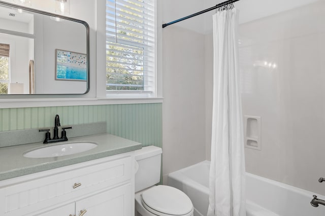 bathroom featuring vanity, toilet, and shower / bath combo with shower curtain